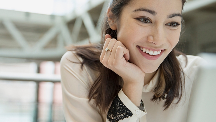 A woman is looking at her laptop easily; image used for HSBC Macau Ways to Bank Online Banking Page