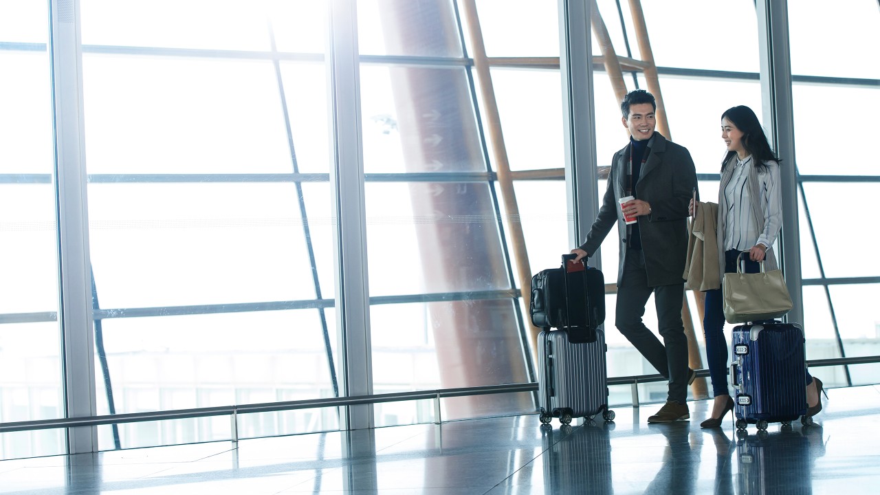 Business man and woman are at the airport; image used for international banking.